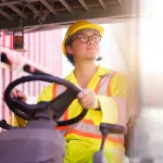 forklift driver working on a digital tablet at container shipyard