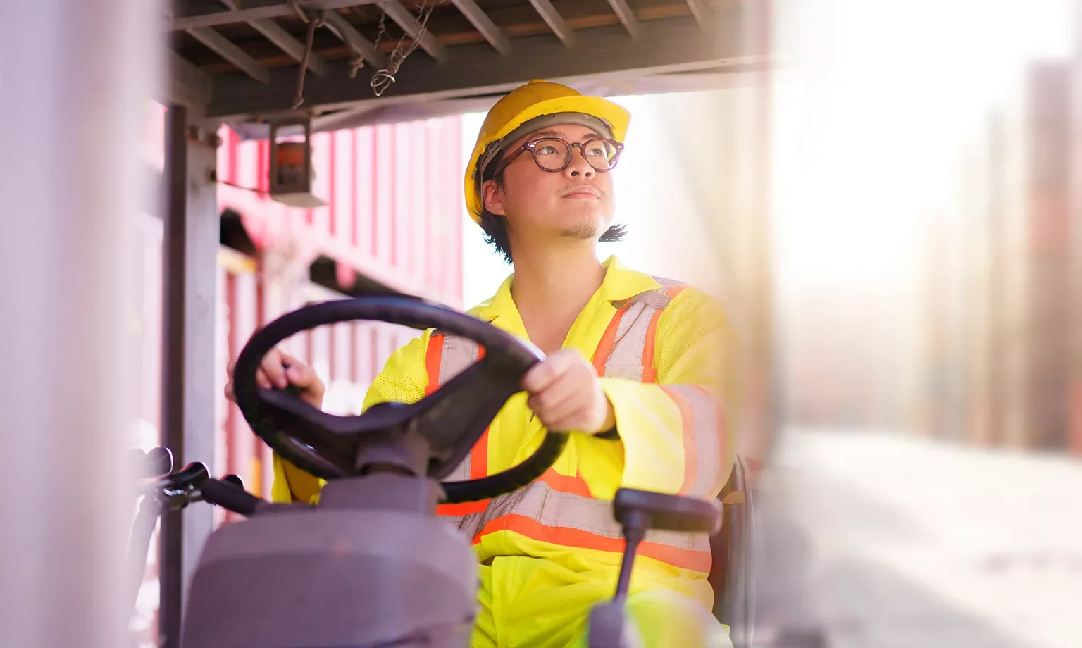 forklift driver working on a digital tablet at container shipyard