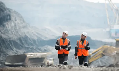 Workers with coal at open pit