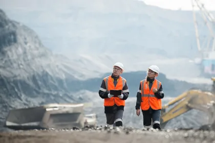 Workers with coal at open pit